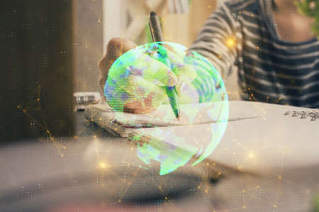 Social network theme hologram over woman's hands writing background. Concept of international people...