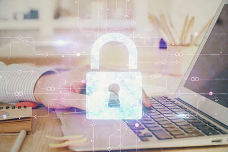 Double exposure of lock icon with man working on computer on background. Concept of network...
