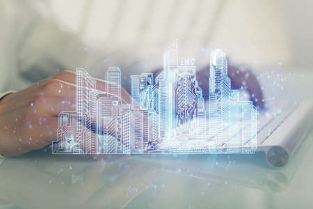 High tech city drawing with businessman working on computer on background. Smartcity concept. Double exposure.の写真素材