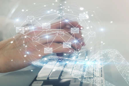 Envelop holograms with businessman working on computer on background. E-mail concept. Multi exposure.の写真素材