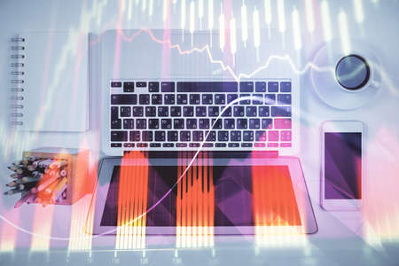 Stock market chart and top view computer on the table background. Multi exposure. Concept of...