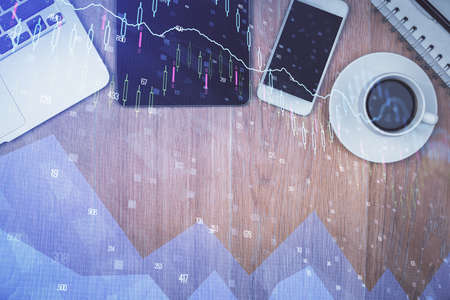 Multi exposure of forex graph hologram over desktop with phone. Top view. Mobile trade platform concept.の写真素材