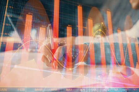 Double exposure of forex chart drawing over people taking notes background. Concept of financial...