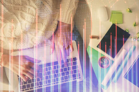 Multi exposure of woman hands working on computer and forex chart hologram drawing. Top View....