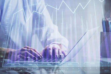 Double exposure of woman hands typing on computer and forex chart hologram drawing. Stock market...