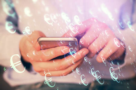 Multi exposure of mans hands holding and using a digital phone and forex graph drawing. Financial market concept.の写真素材