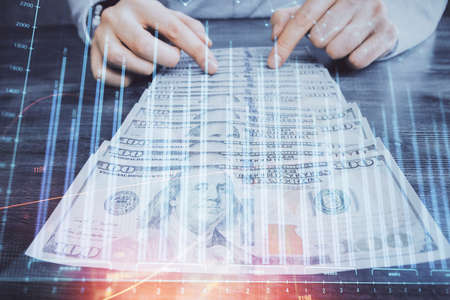 Multi exposure of forex graph drawing hologram and USA dollars bills and man hands. Technical Analysis concept.の写真素材