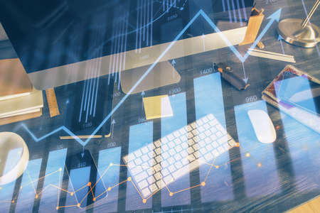 Multi exposure of chart and financial info and work space with computer background. Concept of...