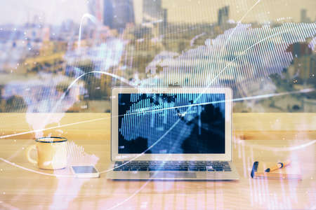 Financial graph colorful drawing and table with computer on background. Double exposure. Concept of international markets.の写真素材