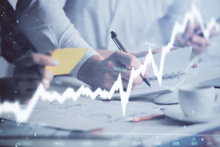 Double exposure of forex graph drawing over people taking notes background. Concept of financial analysisの写真素材