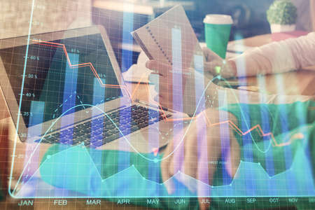 Double exposure of man and woman working together and forex chart hologram. Business concept....