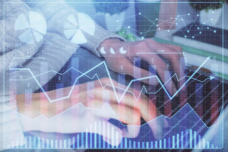 Double exposure of woman hands typing on computer and forex chart hologram drawing. Stock market...