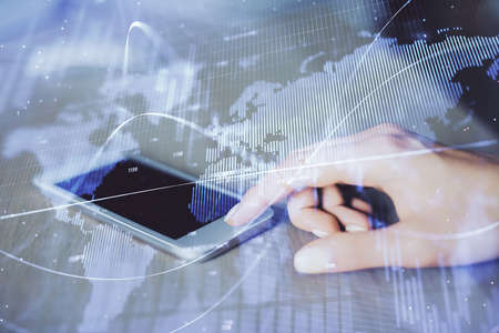 Double exposure of forex chart sketch hologram and woman holding and using a mobile device....
