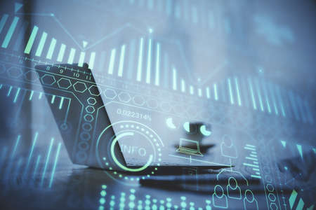 Computer on desktop in office with technology theme hologram. Double exposure. Tech concept.