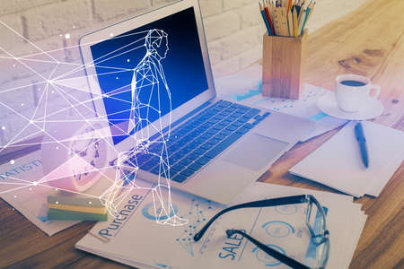 Desktop computer background in office and start up theme hologram drawing. Double exposure. Startup concept.の写真素材