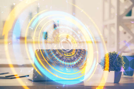 Computer on desktop in office with technology theme hologram. Double exposure. Tech concept.の写真素材