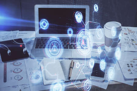 Double exposure of laptop computer and technology theme hologram. Concept of freelance work.の写真素材