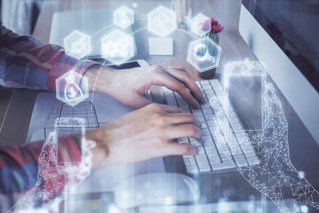 Technology theme hologram with man working on computer on background. High tech concept. Double...