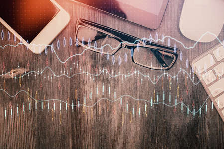 Multi exposure of forex graph hologram over desktop with phone. Top view. Mobile trade platform concept.の写真素材