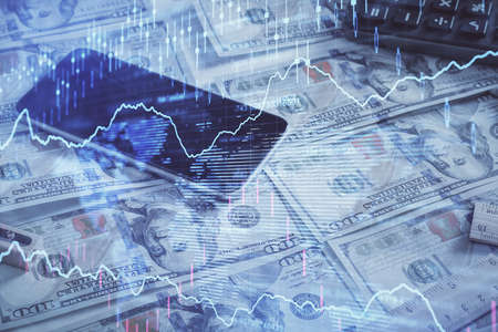 Double exposure of forex graph drawing over us dollars bill background. Concept of financial...