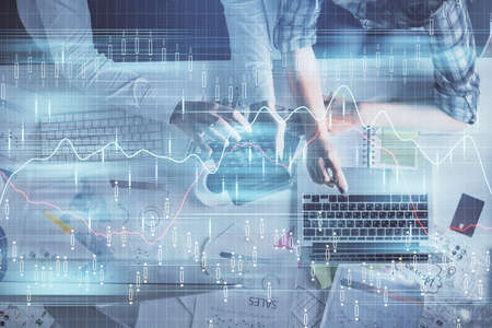 Double exposure of man and woman working together and financial graph hologram drawing. market...