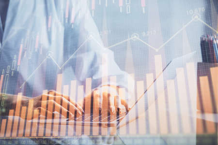 Double exposure of woman hands typing on computer and forex chart hologram drawing. Stock market...