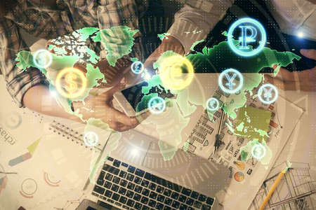 Double exposure of forex graph drawing and man and woman working together holding and using a mobile...
