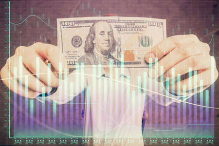 Multi exposure of forex graph drawing hologram and USA dollars bills and man hands. Technical...