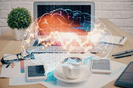 Double exposure of desktop with computer and brain drawing hologram. Artificial intelligence...