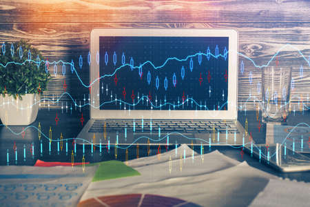 Multi exposure of graph and financial info and work space with computer background. Concept of...