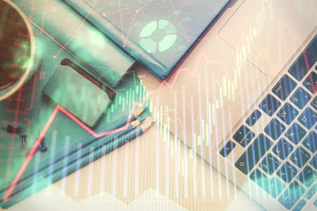 Double exposure of forex graph drawing over desktop background with computer. Concept of financial...