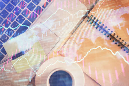 Stock market graph and top view computer on the table background. Double exposure. Concept of financial education.の写真素材