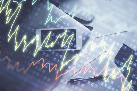 Multi exposure of forex graph hologram over desktop with phone. Top view. Mobile trade platform...
