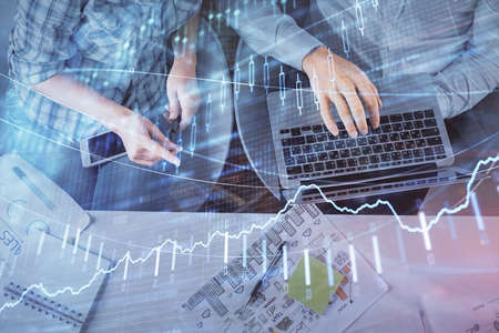 Multi exposure of man and woman working together and forex graph hologram drawing. Financial...