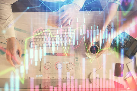 Double exposure of man and woman working together and financial chart hologram drawing. market...