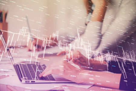 Multi exposure of woman hands typing on computer and financial chart hologram drawing. Stock market...