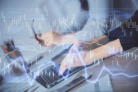 Multi exposure of woman hands typing on computer and financial chart hologram drawing. Stock market...