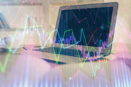 Stock market graph and table with computer background. Double exposure. Concept of financial...
