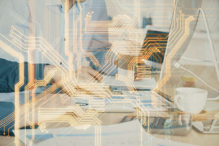 Technology theme hologram with man working on computer on background. High tech concept. Multi...
