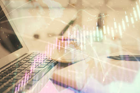 Double exposure of financial chart drawing and desktop with coffee and items on table background....