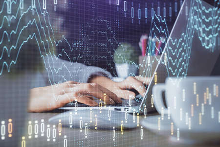 Double exposure of woman hands typing on computer and forex chart hologram drawing. Stock market...