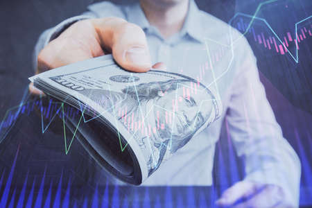 Multi exposure of financial graph drawing hologram and USA dollars bills and man hands. Analysis...