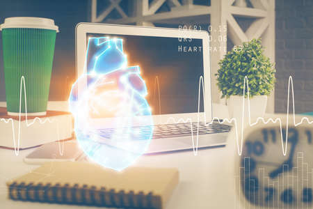 Desktop computer background and heart drawing. Double exposure. Medical study and healthcare concept.の写真素材
