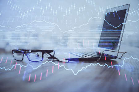 Forex Chart hologram on table with computer background. Double exposure. Concept of financial markets.の写真素材