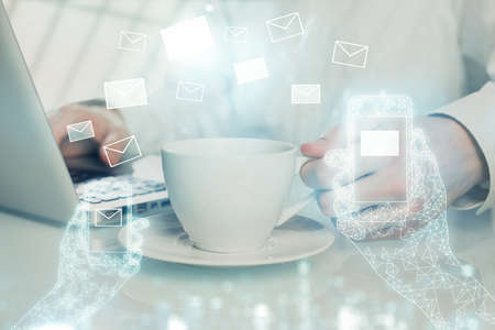 Envelop holograms with businessman working on computer on background. E-mail concept. Multi exposure.の写真素材