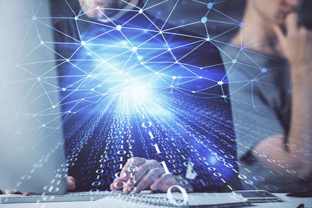 Multi exposure of data internet theme hologram with man working on computer on background. Concept of innovation.の写真素材