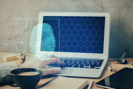 Fingerprint hologram with businessman working on computer on background. Security concept. Double exposure.の写真素材