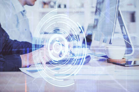 Double exposure of data internet theme hologram with man working on computer on background. Concept...