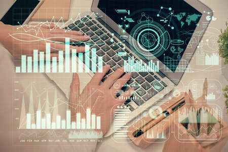 Multi exposure of woman hands typing on computer and forex chart hologram drawing. Stock market...