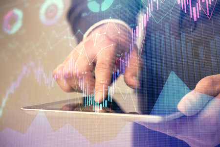 Multi exposure of mans hands holding and using a phone and financial chart drawing. Market analysis...